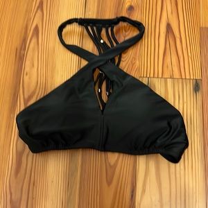 express swimsuit. Black high neck top with gold detailing on back